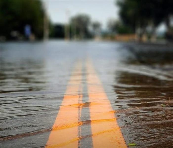 This image shows flooded waters covering the roadway.