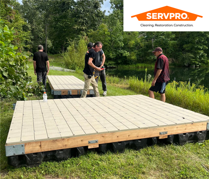 A picture containing SERVPRO of Indianapolis East team building a pond